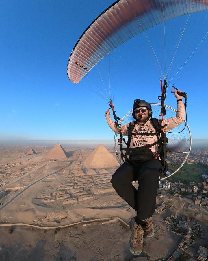 Alex Lang flying a paramotor over the pyramids of Giza